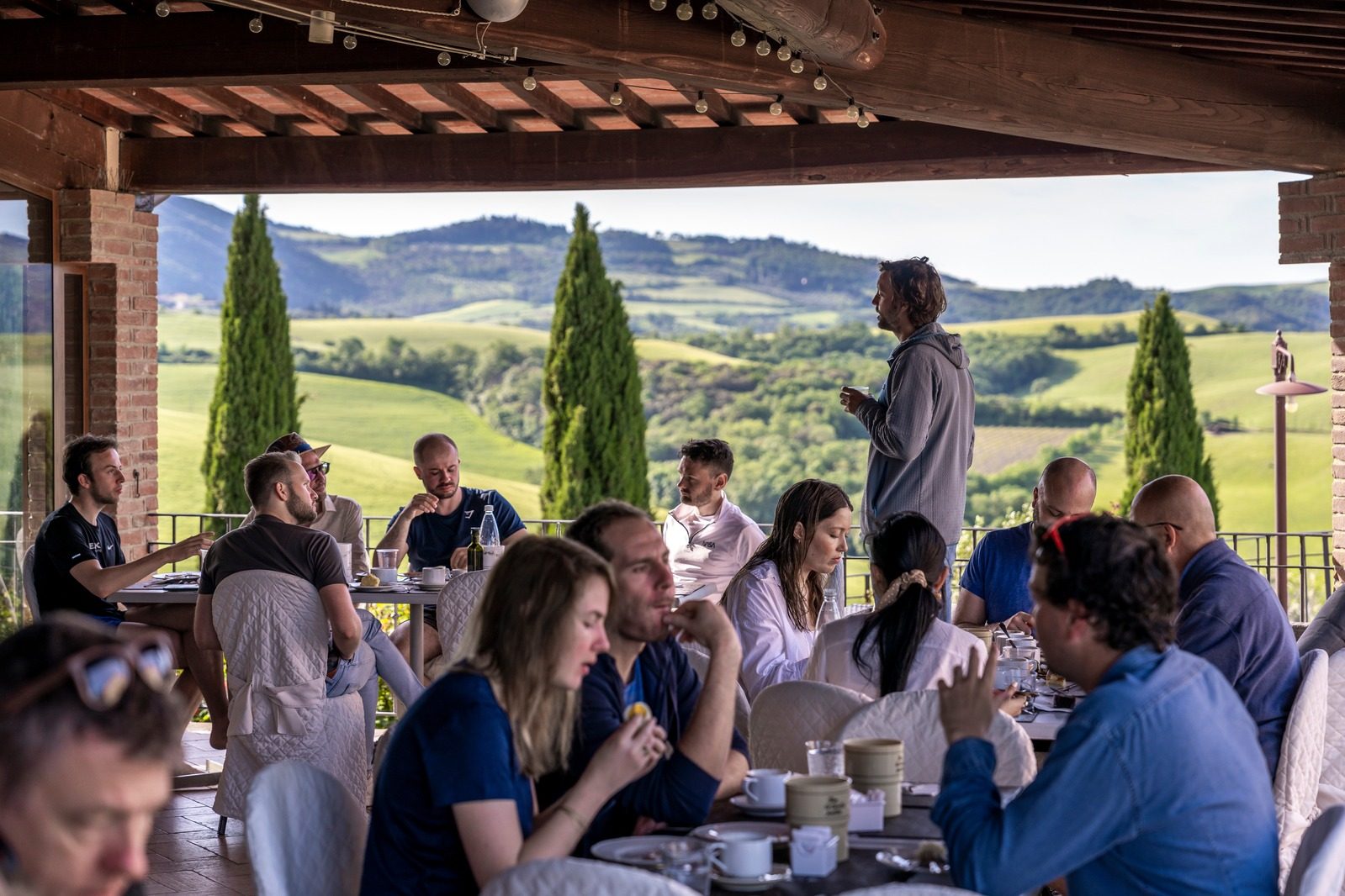 Group lunch on the terrace with Tuscan hills