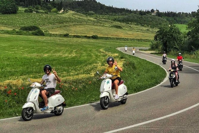 Vespa riders on Tuscan winding roads